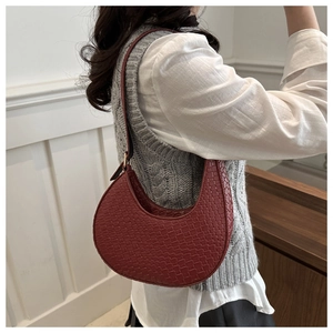 Detailansicht der dunkelroten Webstruktur einer Hobo-Tasche mit verstellbarem Riemen