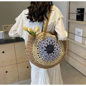 Detail of bohemian woven tote bag with blue gradient circular pattern and leather strap
