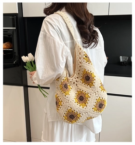 Detailed macro of handmade sunflower crochet hobo bag with white woven texture and yellow petals