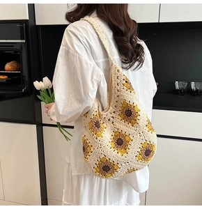 Close-up of handmade crochet sunflower shoulder bag with intricate hollow knit textures