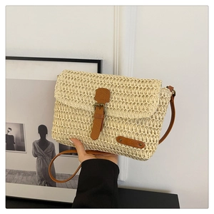 Chic beige straw woven crossbody bag with brown leather strap and vintage metal buckle