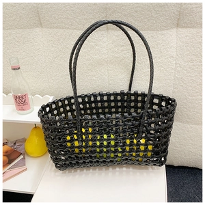 Minimalist black woven tote bag with hollow grid pattern for beach and vacation style
