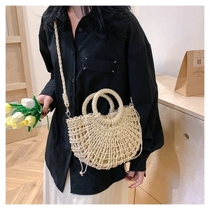 Detail view of woven straw bag with drawstring liner and detachable shoulder strap