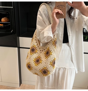 Detail of handmade crochet sunflower tote bag showing bohemian knit texture and floral patterns