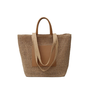 Large summer straw woven tote bag with brown leather handles and hollow texture for beach commute