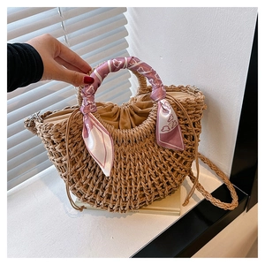 Detail of hand-woven straw tote with cotton drawstring lining and silk scarf handle decor