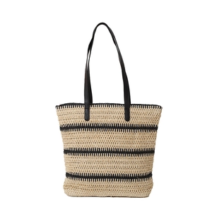 Summer woven straw tote bag with black stripes and leather shoulder straps for beach vacations