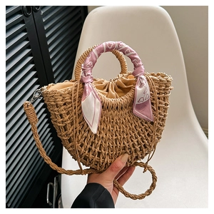 Detail of bohemian straw handbag with heart scarf wrap and drawstring lining