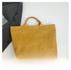 Close-up of a yellow tote bag with DuPont paper texture and white letter printing