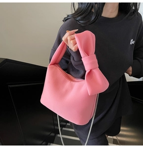 Pink bow handbag for women with smooth matte texture and elegant metal chain strap