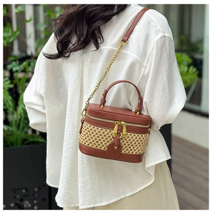 Outdoor lifestyle shot of a vintage straw and brown leather patchwork crossbody handbag