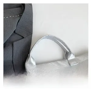 Detail of silver Dupont paper bag with reinforced cross-stitching on the durable handles