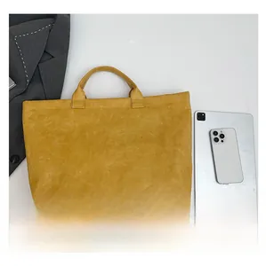 Detailed comparison showing yellow tote bag size next to a tablet and business suit