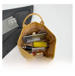Internal view of a yellow tote bag showing spacious capacity for tablets and essentials