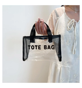 Close-up of a transparent PVC tote bag with black mesh trim and Tote Bag text print