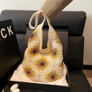 Handmade crochet sunflower tote bag with floral patterns and a minimalist design