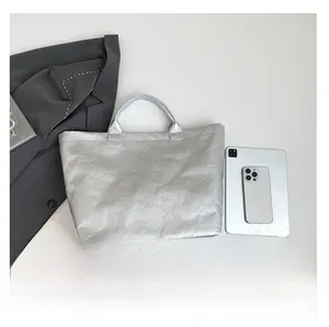 Detail view of metallic silver tote bag with TOTE BAG text and size reference