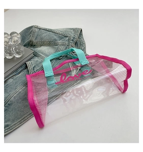 Detail of transparent PVC tote bag with pink Love print and light blue handles