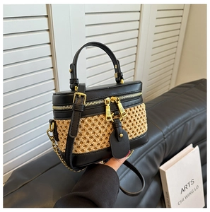 Handheld woven contrast bucket bag with black leather trim and gold chain strap
