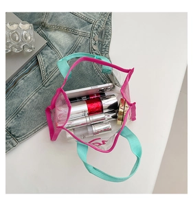 Close-up of pink mesh and PVC transparent handbag showing interior makeup storage