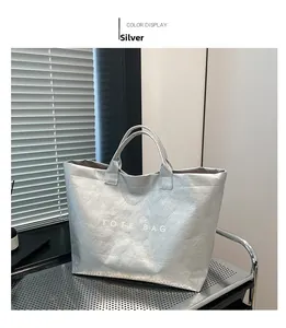 Macro shot of silver crinkled texture fabric and TOTE BAG lettering on a retro carryall