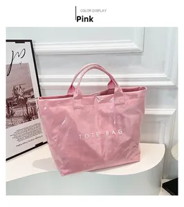 Detail view of pink waterproof DuPont paper tote bag with TOTE BAG print on white stand