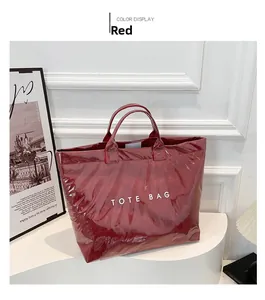 Detail view of red waterproof DuPont paper tote bag with white text and glossy crinkle finish