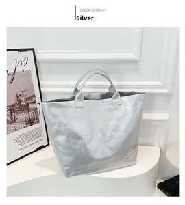 Detailed close-up of metallic silver DuPont paper tote bag with unique crinkled texture