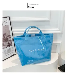 Detail view of the bright blue waterproof tote bag featuring white TOTE BAG lettering