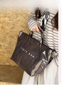 Macro shot of brown textured tote bag with TOTE BAG print under waterproof PVC layer