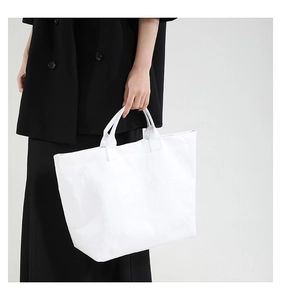 Close-up of a white Tyvek tote bag with natural wrinkled texture and minimalist style