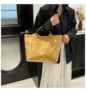 Detail of waterproof mustard yellow tote bag featuring a textured crinkled paper finish
