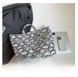 Detailed comparison of the snakeskin tote bag with a tablet and business blazer