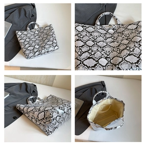 Macro view of snakeskin print tote bag showing interior lining and large capacity pocket
