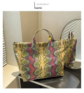 Detail shot of multicolor snakeskin print tote bag with white TOTE BAG lettering