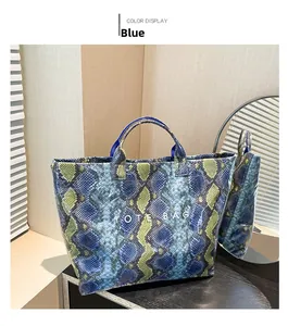 Detail shot of the blue snakeskin pattern texture and TOTE BAG print on the tote bag