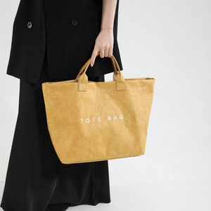 Minimalist yellow tote bag with white TOTE BAG text print and vintage crinkle texture