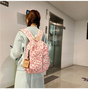 Detail view of pink leopard print backpack with a cute toast plush pendant