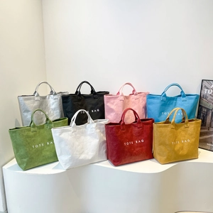 Minimalist Dupont paper tote bags set in eight vibrant colors with printed letters