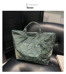 Detail of green snake pattern tote bag with TOTE BAG print on glossy finish