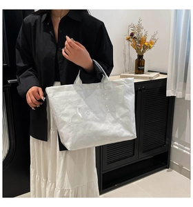 Close-up of a white waterproof Tyvek tote bag with wrinkled texture and printed text