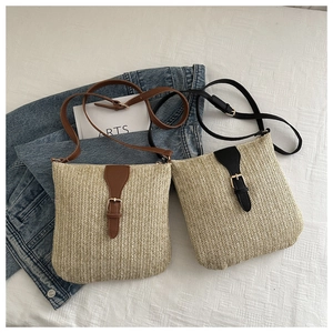 Flat lay of straw square crossbody bags with black and brown leather trim detailing