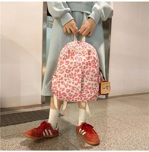 Detailed view of pink leopard print school bag with a cute toast plush keychain pendant