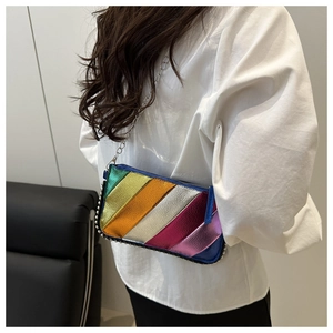 Detailed close-up of rainbow metallic patchwork leather bag with studded trim and chain strap