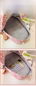 Internal display of leopard print backpack showing spacious multi-layer storage compartments