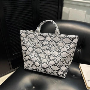 Chic black and white snake print tote bag with double handles and TOTE BAG lettering