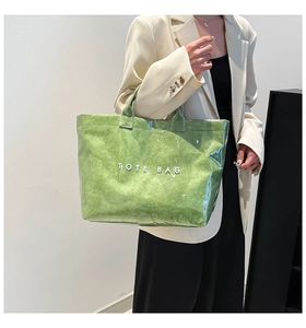 Green Tyvek tote bag with waterproof PVC layer shown as a side view on a model