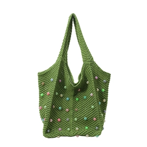 Green knit tote bag with colorful pearl accents and hand-woven bohemian crochet pattern