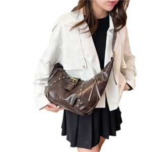 Sac bandoulière rétro marron foncé avec rivets et bandoulière réglable sur modèle