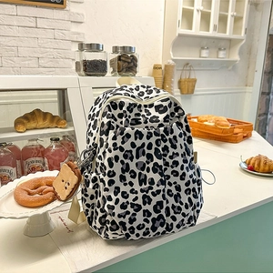 Fashionable leopard print backpack with cute plush toast pendant and side pockets